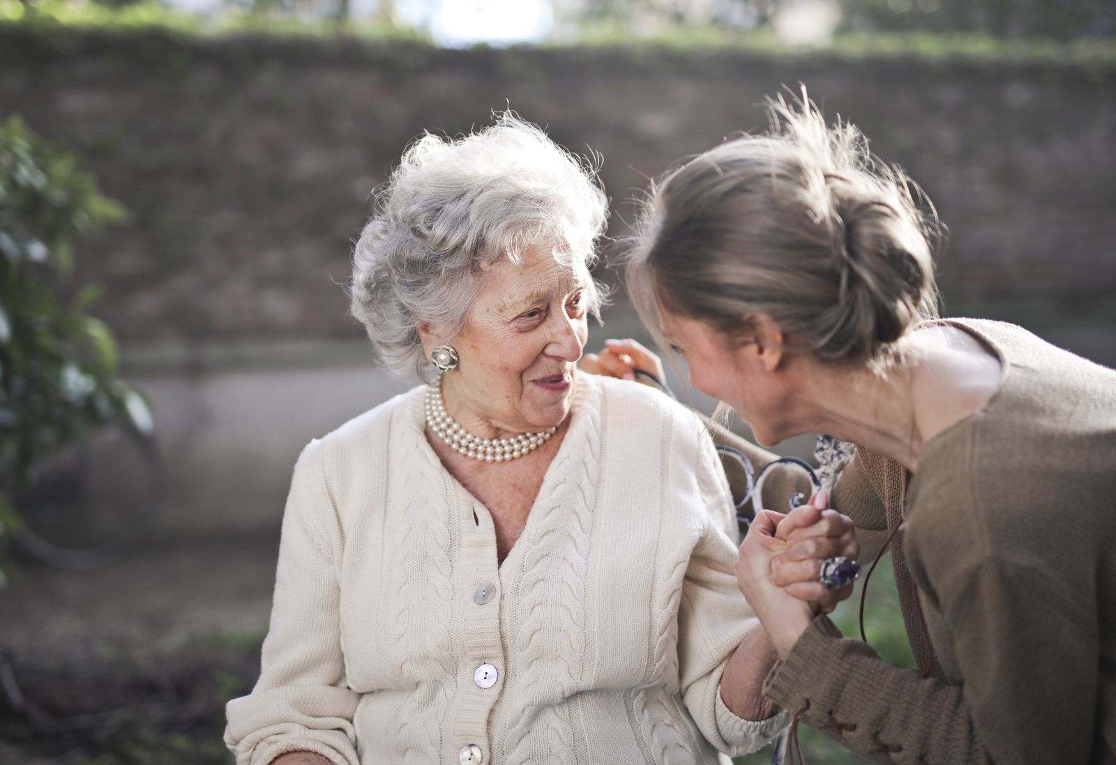 An older woman sharing a quiet conversation